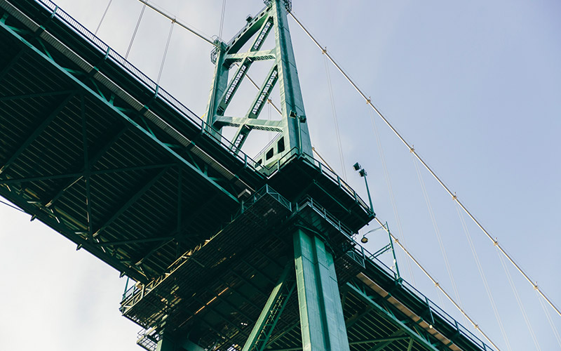 Steel truss tower of a green bridge seen from below
